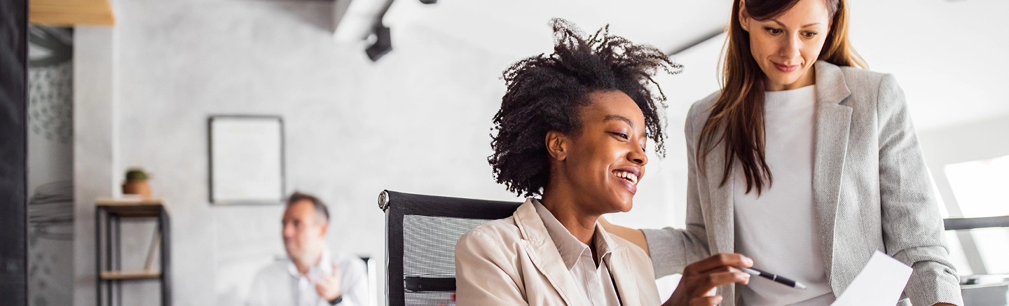 Two professionals collaborating in an office setting, illustrating Hays temporary and contract recruitment services for accessing niche skills and workforce agility.
