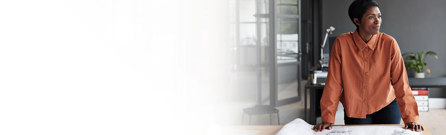 Woman in office with property designs on table