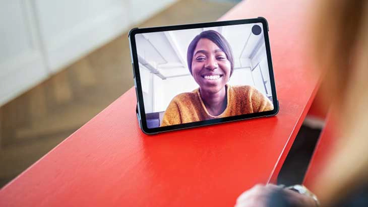 Smiling woman on tablet screen