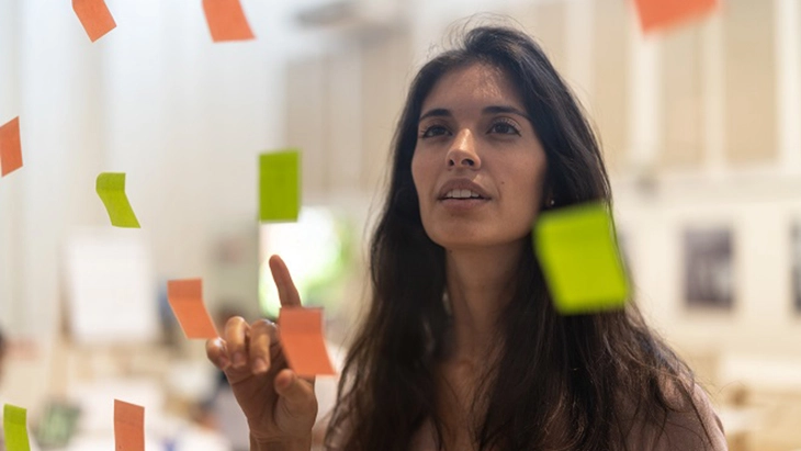 Woman reading notes on a board