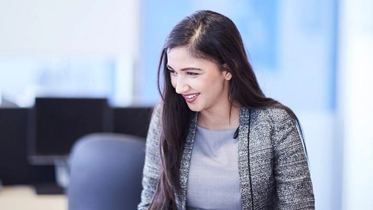 Young woman with long dark hair in work space
