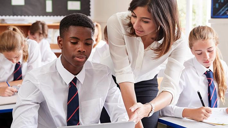 Teacher helping students