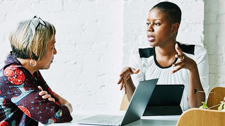 Two women talking face to face