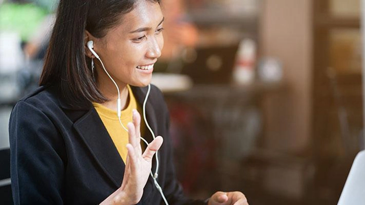 Women using headphones and having a remote interview