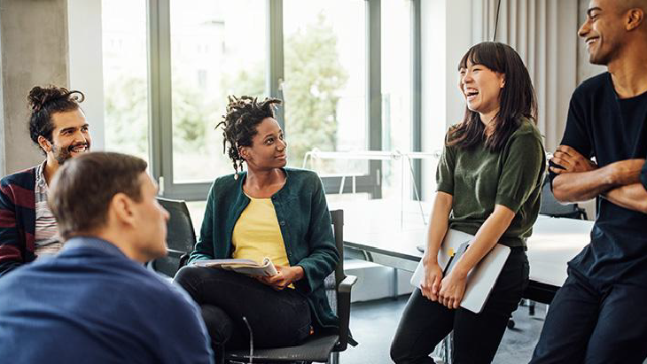 Colleagues in a meeting and laughing