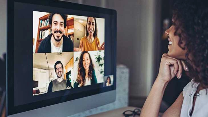 Woman speaking with colleagues in online meeting