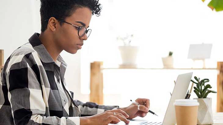 Woman sitting at desk and working on laptop