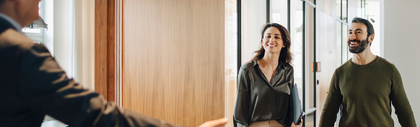 Two professionals walking through a bright modern office, representing fresh career opportunities and the theme ‘New year, new momentum’ from the Hays Career Hub