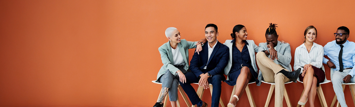 Group of professionals seated together in a modern studio setting, representing career paths for newly qualified accountants.